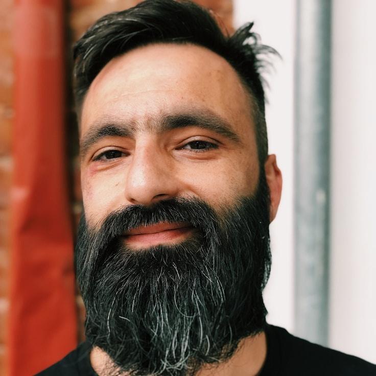 Kaveri Mehta, Lead Design Curator at Glow Kind Paper, reviewing corporate floral arrangements